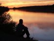 man sitting on shore contemplating life