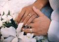 bride and groom holding hands showing wedding rings